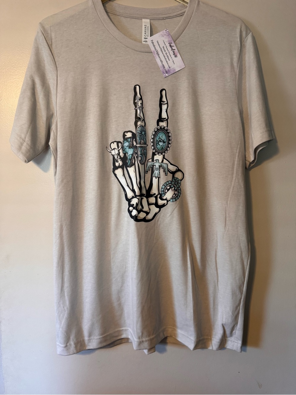Bella Canvas Light Tan Tee with Turquoise Accent Skeleton Hand Graphic